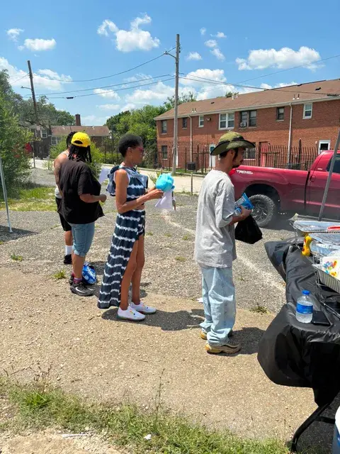 Community volunteers supporting an outdoor outreach event