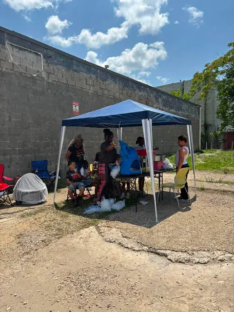 Community members gathering at the outdoor pop-up