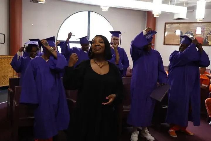 Graduate celebrating with a community leader
