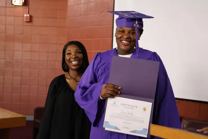 Graduate celebrating with supporters