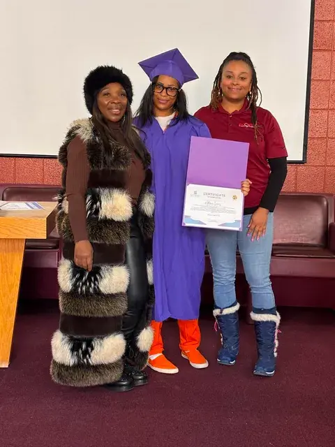 Graduate proudly displaying her certificate